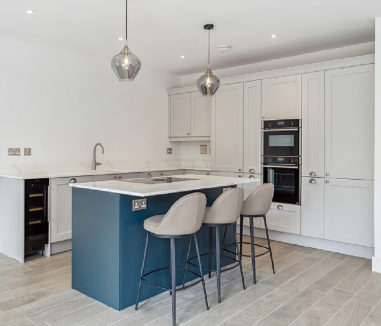 Internal photo of kitchen with kitchen island and bar stools